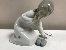 A Lladro figurine : Girl with Slippers, model 4523, height 13 cm, boxed.