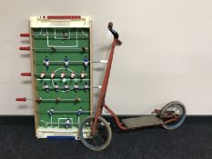 A child's scooter together with a table top football game