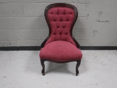 A Victorian style upholstered armchair