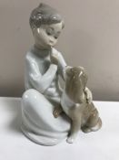 A Lladro figurine : Boy with Dog, model 4522, height 19 cm, boxed.