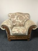 A wood framed armchair upholstered in a floral fabric