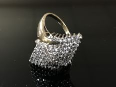 A diamond cluster ring, upon a yellow gold shank,