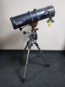 A Celestron telescope with instructions and tripod