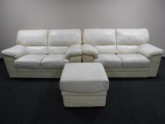 A pair of cream leather two seater settees with matching footstool