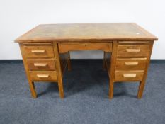 An early 20th century office desk with tooled leather top
