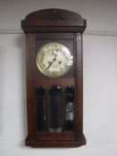 An early twentieth century oak wall clock