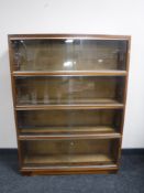 A mid 20th century four tier stacking glazed door bookcase