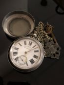 A silver English lever pocket watch suspended on white metal chain,