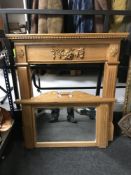 A light pine carved fire surround with mirror