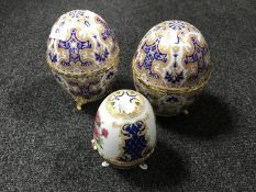A pair of Russian style egg caskets together with one other