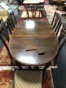 A late Victorian carved mahogany extending oval dining table, with leaf and winder,