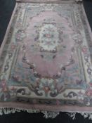 A pink Chinese fringed carpet,