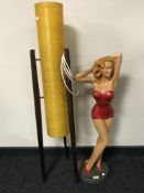 A figure of a lady in red dress together with a 1970's rocket lamp