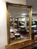 A gilt framed bevelled wall mirror