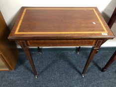 An Edwardian mahogany and satinwood inlaid foldover card table