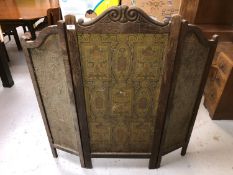 An antique carved oak three fold screen