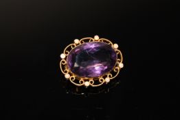 A 15ct gold brooch set with a large amethyst and seed pearls CONDITION REPORT: One