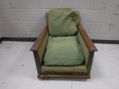 A late Victorian oak fireside armchair