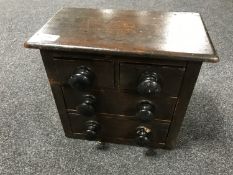 A 19th century miniature four drawer pine chest