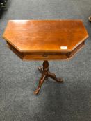 A reproduction mahogany side table on tripod legs