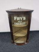 A mahogany bow-fronted glazed cabinet with later decoration "Fry's Milk Chocolate"