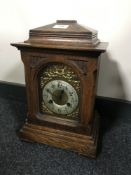 An oak cased bracket clock with brass dial