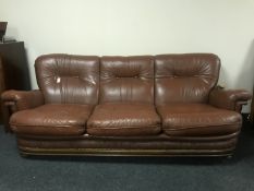 A brown leather button leather three seater settee