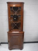 A mahogany corner display cabinet