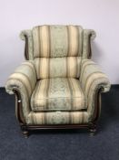 A wood framed armchair in a Regency style fabric