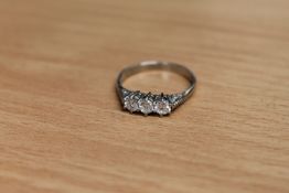 A platinum three stone diamond ring,