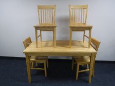 A contemporary beech dining table and four chairs