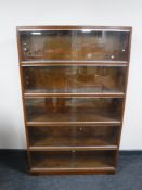 A mid 20th century five tier stacking glazed door bookcase