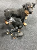 Four resin figures of Rottweilers