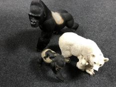 Three resin figures of a polar bear and two gorillas