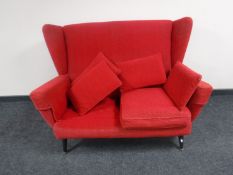 A mid 20th century Parker Knoll red two seater settee