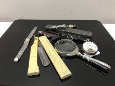 A silver handled magnifying glass, two vintage straight razors, soldier's notebook,