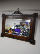 An early 20th century carved oak bevelled mirror