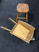 A Taylor child's wheel barrow and a pine kitchen stool