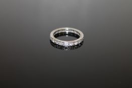 A white metal diamond full eternity ring, size K/L.