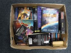 A box containing a collection of science fiction and fantasy books; Star Trek,