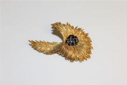 An 18ct gold sapphire and diamond floral spray brooch CONDITION REPORT: 20.