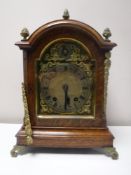 A late Victorian oak eight day bracket clock with brass dial and mounts