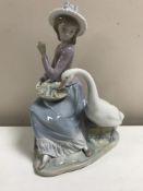 A Lladro figurine : Goose Trying to Eat, model 5034, height 25 cm, boxed.
