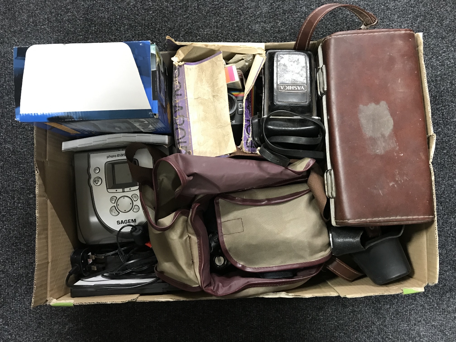 A box of camera bags and cameras including Zenit 11 with lens, Yashica, Polaroid etc,