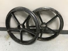A pair of vintage cast iron wagon wheels,