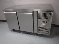 A stainless steel commercial bench fridge