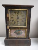 An antique pine cased American mantel clock