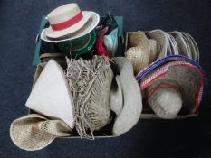 Three boxes containing a large quantity of fancy dress hats, wicker sun hats,