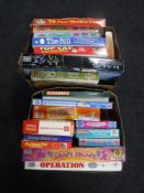 Two boxes of a collection of board games and puzzles