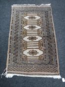 A fringed Afghan rug
